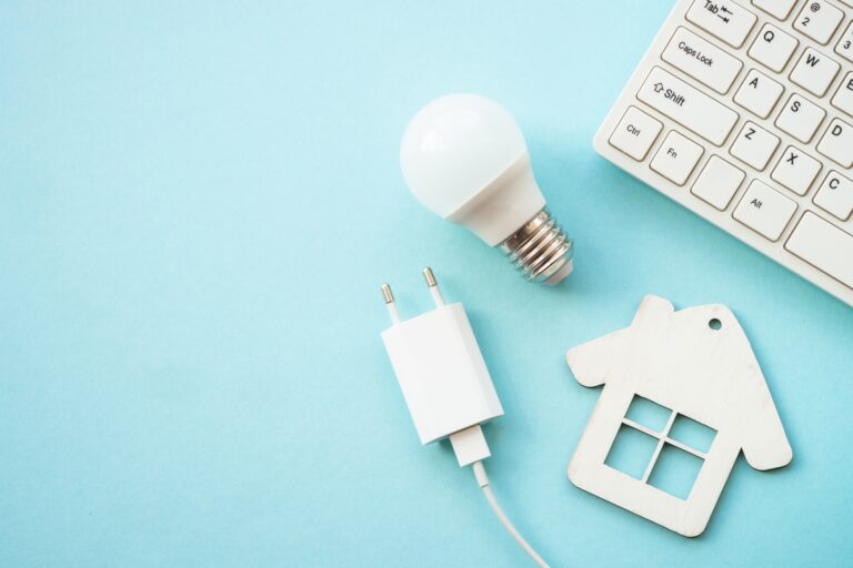 Saving electricity. LED lamp, wire with plug and house.
